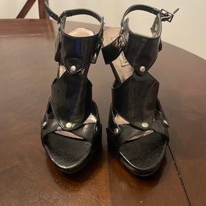 Stylish Steve Madden black sandal with silver studs and and ankle strap.